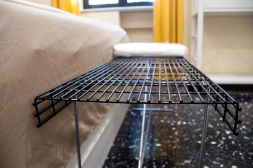 a metal bench sitting next to a couch at Luxury Suite Station in Barletta