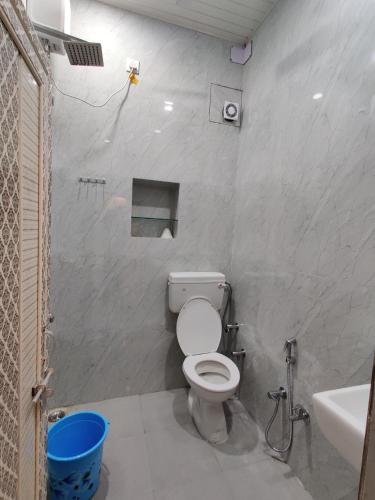 a bathroom with a toilet and a sink at A ShivAngan Heritage Home Stay Near Ghat in Varanasi