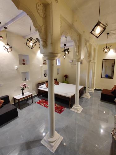 a large room with a bed and a couch at A ShivAngan Heritage Home Stay Near Ghat in Varanasi