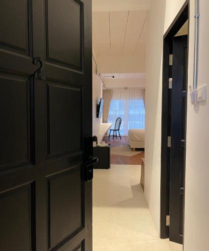 an open door to a room with a bedroom at GOODTHINGS Cafe & Hotel in Bophut 