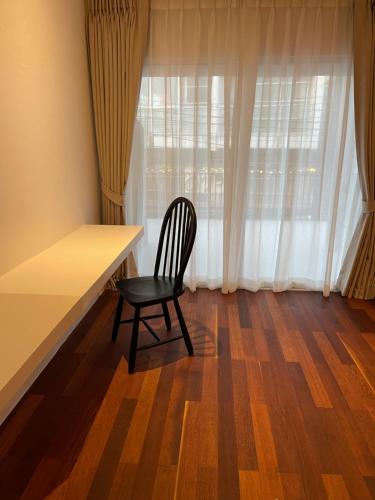 a chair sitting at a desk in front of a window at GOODTHINGS Cafe & Hotel in Bophut 