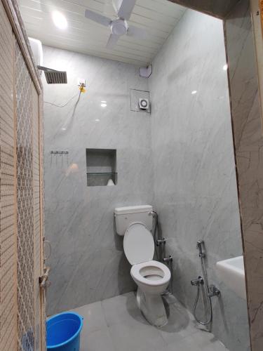 a bathroom with a toilet and a sink at A ShivAngan Heritage Home Stay Near Ghat in Varanasi