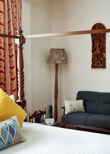 a living room with a couch and a lamp at Shangrila Casa-Premium Homestay in Lovedale