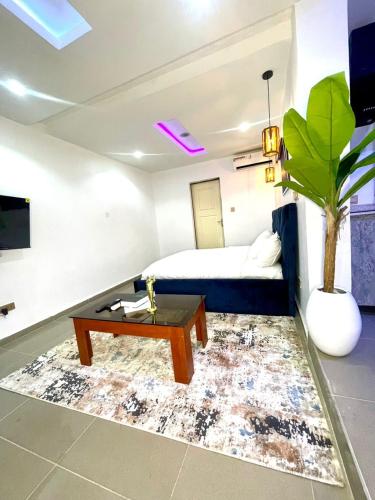 a living room with a bed and a coffee table at Wine House, Maitama, Abuja in Abuja