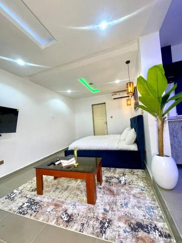 a living room with a bed and a coffee table at Wine House, Maitama, Abuja in Abuja
