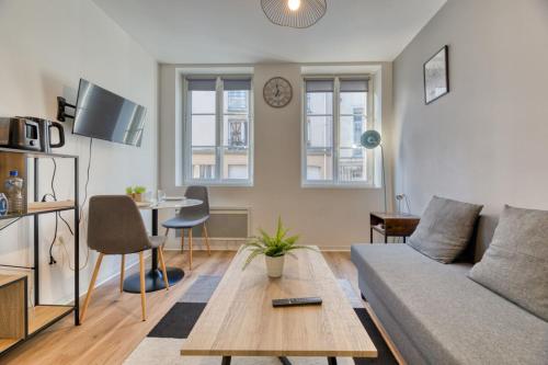 un salon avec un canapé et une table dans l'établissement Le Thibaut studio rénové au coeur de Rouen, à Rouen