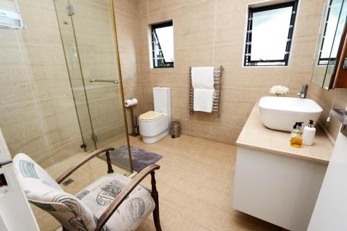 a bathroom with a toilet and a sink at Sea Dreams Guesthouse in Ballito