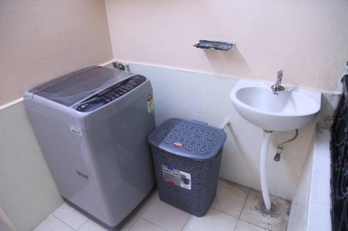 a small bathroom with a sink and a trash can at Royal Residency 3BHK, Near Rameshwaram cafe, HiTech City in Hyderabad