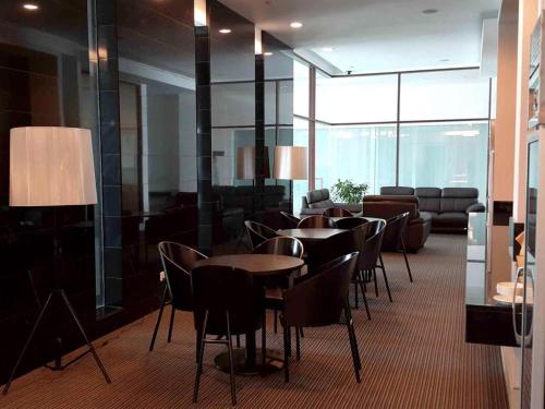 a group of tables and chairs in a room at RH Hotel Sibu in Sibu