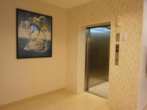 a bathroom with a shower and a picture on the wall at Hotel Kawan in Kampar