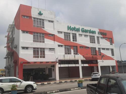 a hotel garden building with cars parked in front of it at THE GARDEN HOTEL (BANTING) SDN. BHD. in Banting