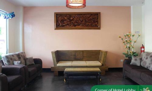 a living room with a couch and a coffee table at THE GARDEN HOTEL (BANTING) SDN. BHD. in Banting