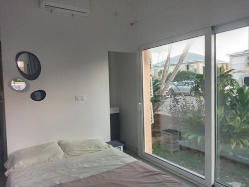 Postel nebo postele na pokoji v ubytování Petit coin de paradis