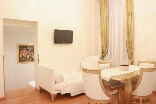a white dining room with a table and chairs at Al Bailo Di Venezia in Venice