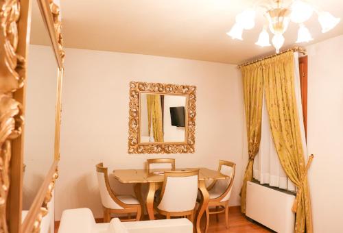 a dining room with a table and chairs and a mirror at Al Bailo Di Venezia in Venice