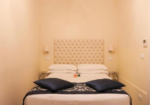 a bedroom with a bed with two pillows on it at Al Bailo Di Venezia in Venice