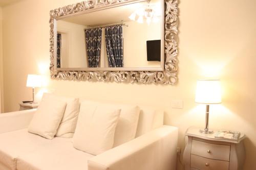 a large mirror above a bed in a bedroom at Al Bailo Di Venezia in Venice
