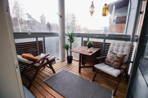 a balcony with two chairs and a table on a balcony at Romantic Sauna Retreat Near Sello and Nature Perfect in Espoo