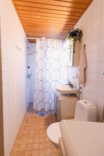 a bathroom with a sink and a toilet and a window at Romantic Sauna Retreat Near Sello and Nature Perfect in Espoo