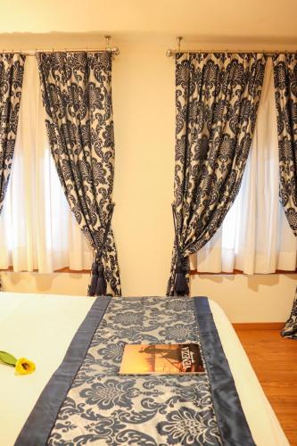 a bedroom with a bed with a book on it at Al Bailo Di Venezia in Venice