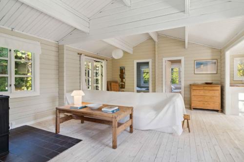a living room with a couch and a table at Lovely Summer House In North Zealand in Vejby