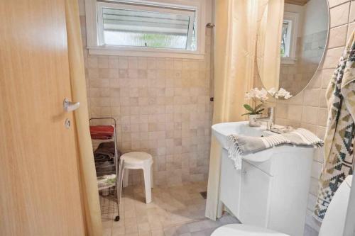 a bathroom with a white sink and a mirror at Cozy And Calm - Close To Beach And Great Terraces in Slagelse