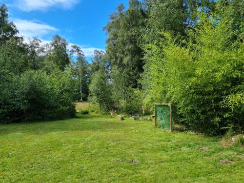 a field with a sign in the grass at Large Child-Friendly Holiday Home North Sealand in Frederiksværk