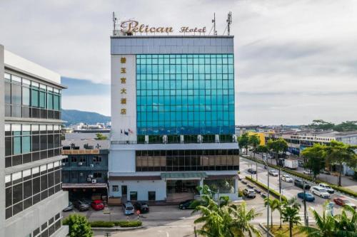 a building with a sign on top of it at Pelican Hotel in Batu Pahat