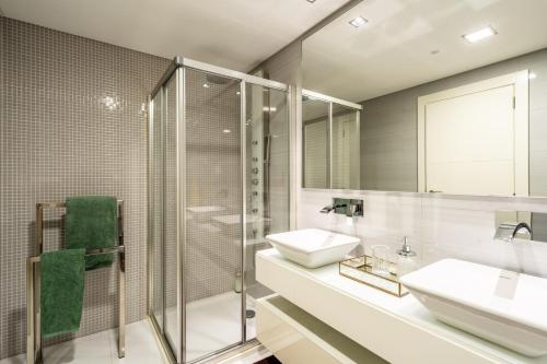 a bathroom with two sinks and a glass shower at Manny Quinta Vitória, by Pausa Holiday Rentals in Funchal