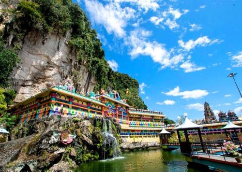 a hotel on the side of a mountain with a waterfall at Hartamas Business Hotel in Kuala Lumpur