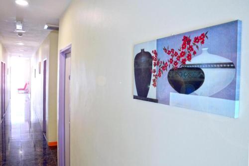 a painting of two vases on a wall at Hotel Zamburger Bentong in Bentong