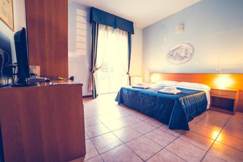 Ένα ή περισσότερα κρεβάτια σε δωμάτιο στο Hotel La Gaietta