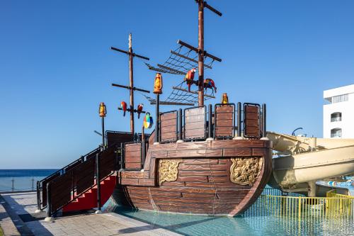 a large wooden boat sitting in the water at Petra Mare in Ierápetra