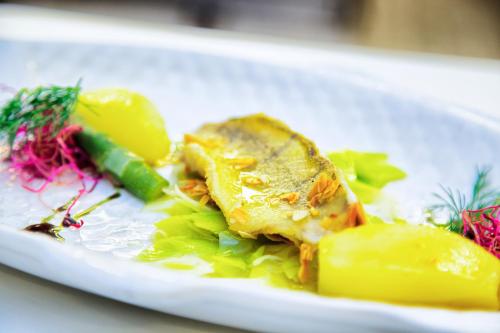 a white plate of food on a table at Kaisers Tanne - Premium Alles Inklusive Hotel in Breitnau