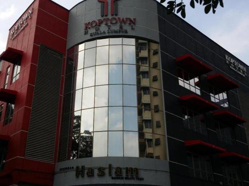 a red and black building with a sign on it at Hotel Zamburger Bangsar (Previously Koptown Hotel Bangsar) in Kuala Lumpur