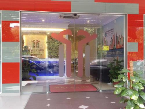 a store front door with the word shop written in red at Hotel Zamburger Bangsar (Previously Koptown Hotel Bangsar) in Kuala Lumpur