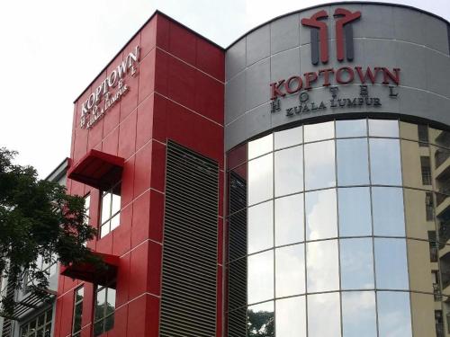 a red and white building with a sign on it at Hotel Zamburger Bangsar (Previously Koptown Hotel Bangsar) in Kuala Lumpur