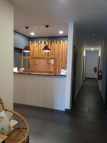 a hallway leading to a kitchen with a bar at Sg. Paka Hotel in Paka