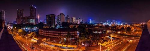 a night view of a city with buildings and street lights at The Hulo Hotel & Gallery in Kuala Lumpur