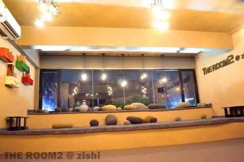 a room with a large window with lots of balls at THE ROOM2 @ Zishi in Kota Bharu