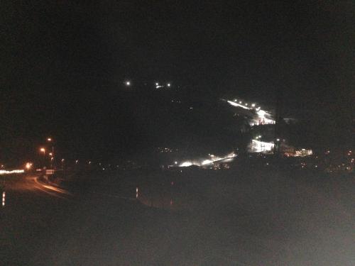a city at night with lights on a hill at Appartements Schweiberer in Ried im Zillertal