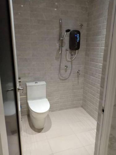 a bathroom with a toilet and a shower stall at Twin Star Hotel in Tanjung Malim