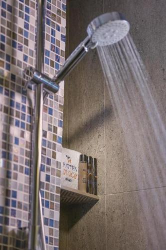 a shower in a bathroom with a shower head at Hatten Place Melaka in Melaka