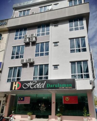 a tall white building with a sign in front of it at Hotel Darulaman Alor Setar in Alor Setar