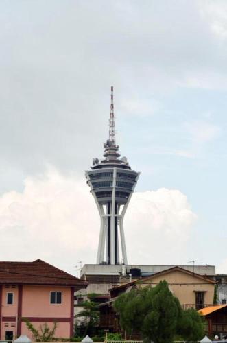 a tall tower in the middle of a city at Hotel Darulaman Alor Setar in Alor Setar