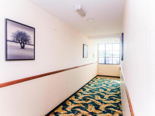 an empty hallway with a rug on the floor at Bay Hotel in Lahad Datu