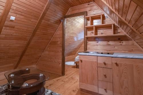a bathroom with a toilet in a wooden cabin at Villa Ela in Kupres
