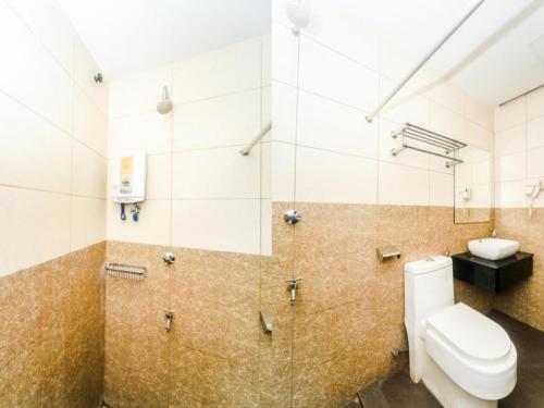 a bathroom with a toilet and a sink at Bay Hotel in Lahad Datu