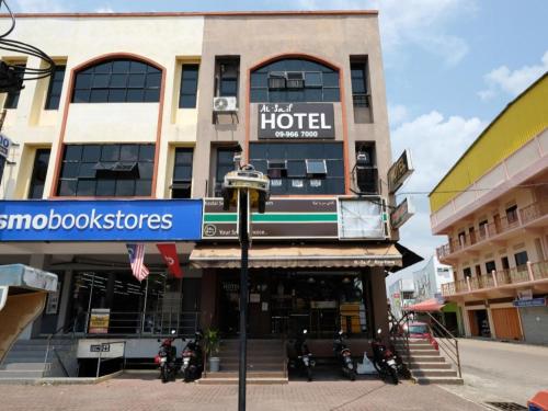 a hotel on a street with motorcycles parked in front of it at OYO 44123 Hotel Al-Saif in Kuala Kerai