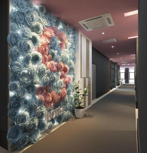 a wall with roses painted on it in a hallway at S Hotel in Johor Bahru